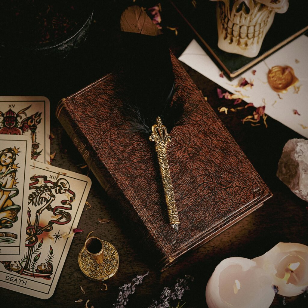 Flat lay of tarot cards, feather pen, and vintage decor evoking a mystical theme.