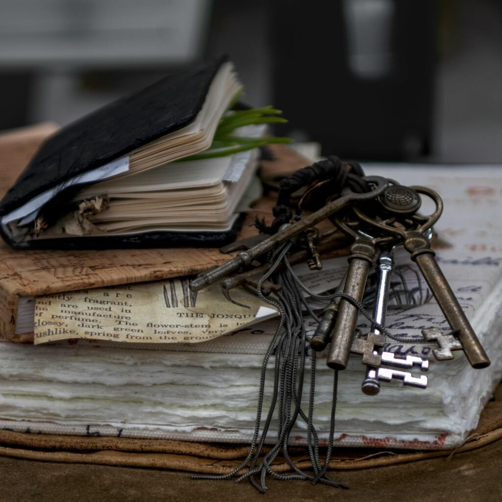 Aesthetic still life of vintage journals and antique keys on layered paper, evoking a sense of history and nostalgia.